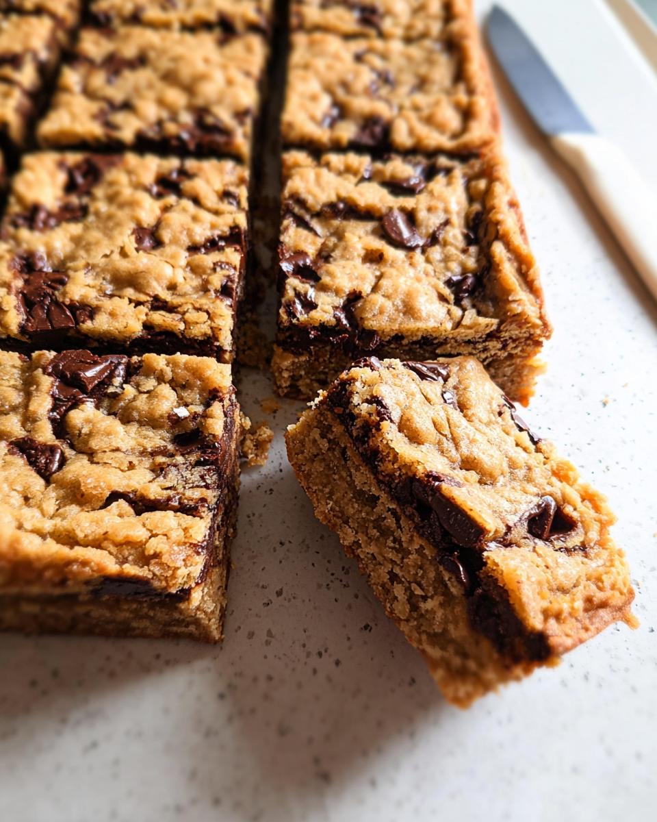 Close-up of thick, chewy chocolate chip bar cookies for a crowd, cut into squares.