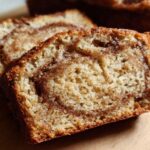 Close-up of two thick slices of Cinnamon Swirl Banana Bread showing the moist crumb and rich cinnamon swirl.