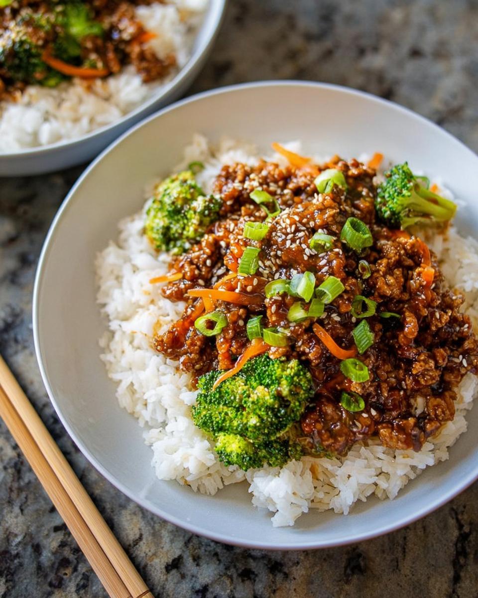 A bowl of Healthy College Lunch Ideas: Ground Turkey Teriyaki Stir-Fry served over white rice with broccoli and sesame seeds.