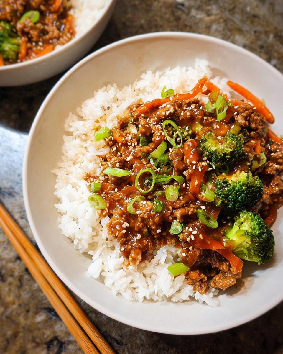 Close-up of Healthy College Lunch Ideas: Ground Turkey Teriyaki Stir-Fry served over white rice, garnished with sesame seeds.