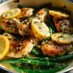 Close-up of pan-seared Healthy Lemon Garlic Chicken and Vegetable Skillet with bright green beans and lemon slices.