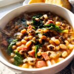 A close-up of a bowl of hearty black-eyed pea soup with spinach and ham, perfect for The Ultimate Soup Recipes Guide for Beginners.