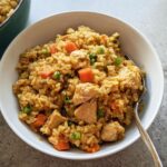 A close-up of a white bowl filled with flavorful chicken fried rice, part of our Rice Bowls Recipes in 12 Minutes.
