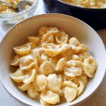 A bowl of creamy shell pasta, seasoned with black pepper, illustrating an easy dinner recipe.