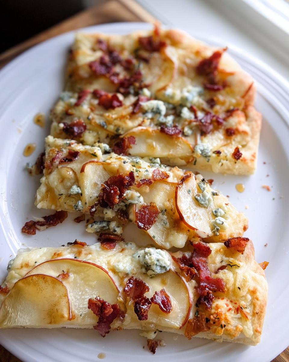 Three slices of gourmet pizza topped with thin apple slices, bacon, and blue cheese, part of 10-Ingredient Pizza Night Recipes.