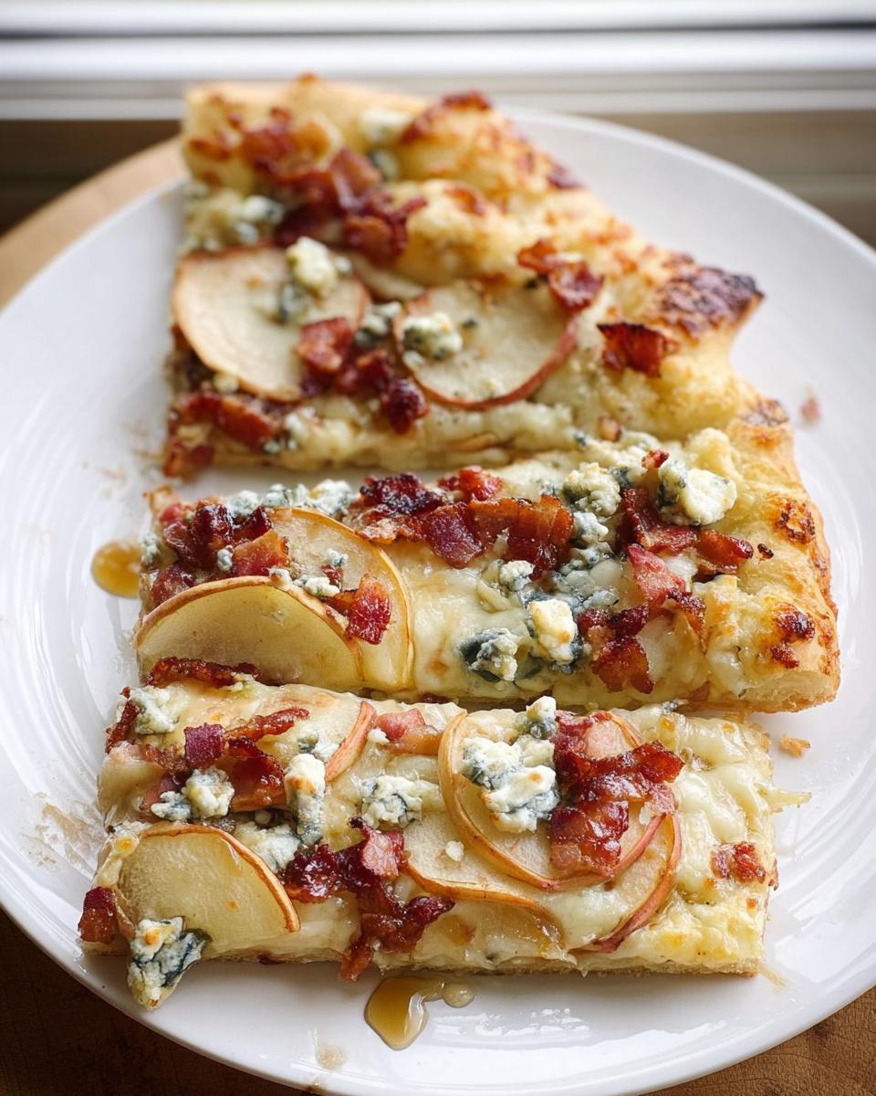 Three rectangular slices of gourmet pizza topped with bacon, apple slices, and blue cheese, part of 10-Ingredient Pizza Night Recipes.
