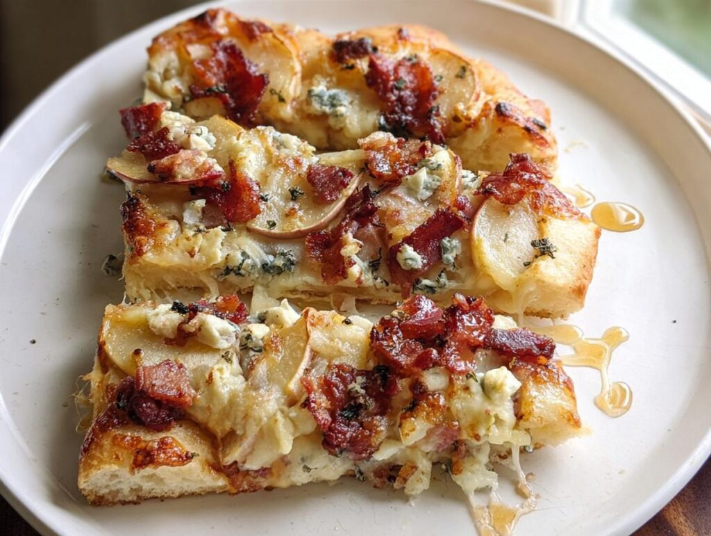 Slices of gourmet pizza topped with pear, bacon, blue cheese, and drizzled with honey, part of 10-Ingredient Pizza Night Recipes.