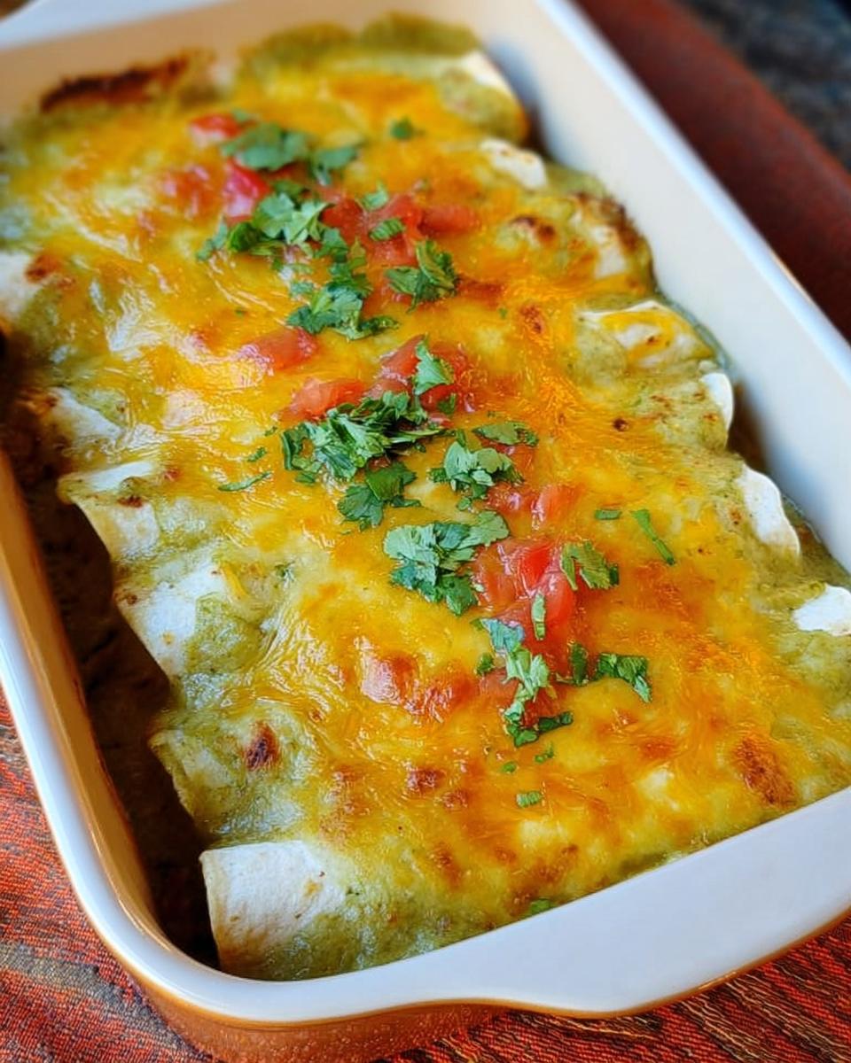 Close-up of baked chicken enchiladas covered in green sauce and melted cheddar cheese, perfect for Chicken Recipes Meal Prep.