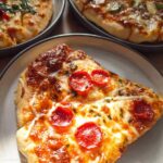 Close-up of two slices of pepperoni pizza with melted cheese, part of The Ultimate Pizza Night Recipes Guide.