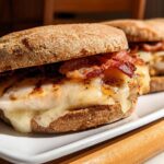 Close-up of a grilled chicken sandwich with melted cheese and bacon, perfect for Restaurant-Style Easy Dinner Recipes at Home.