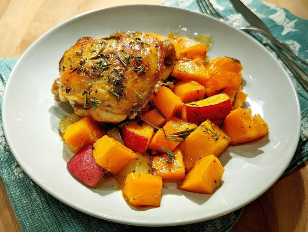 Crispy roasted chicken thigh served with cubes of roasted butternut squash and herbs.