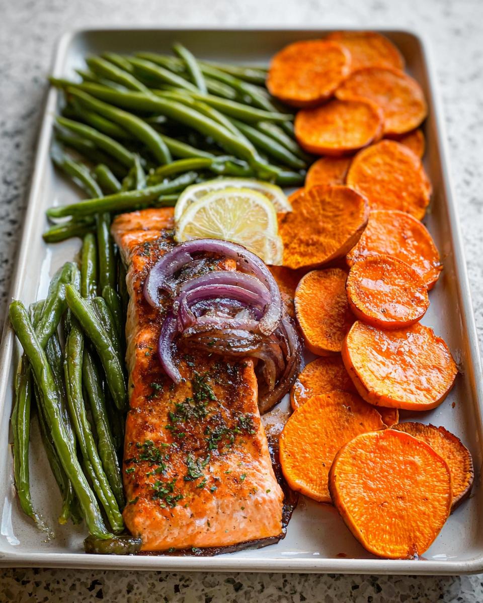 A perfectly cooked salmon fillet with roasted sweet potatoes and green beans, ideal for Salmon Recipes Meal Prep.