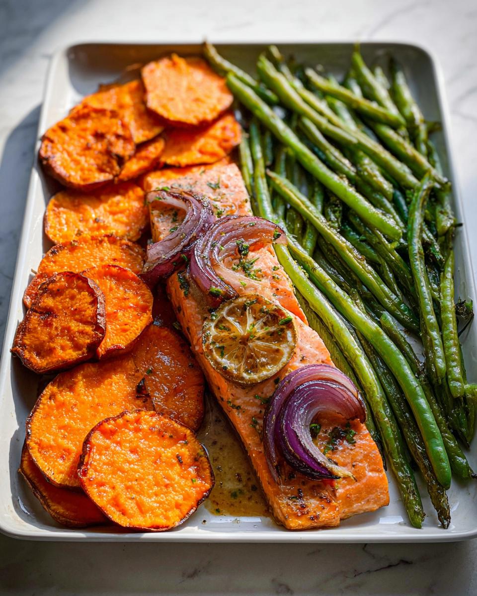 A perfectly cooked salmon fillet served with roasted sweet potato rounds and green beans, ideal for Salmon Recipes Meal Prep.