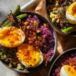 Close-up of a bowl featuring purple rice, green vegetables, and soft-boiled eggs, part of The Ultimate Egg Recipes Guide for Beginners.
