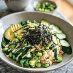 A vibrant vegetarian rice bowls recipe featuring brown rice, avocado, edamame, cucumber, and nori strips.