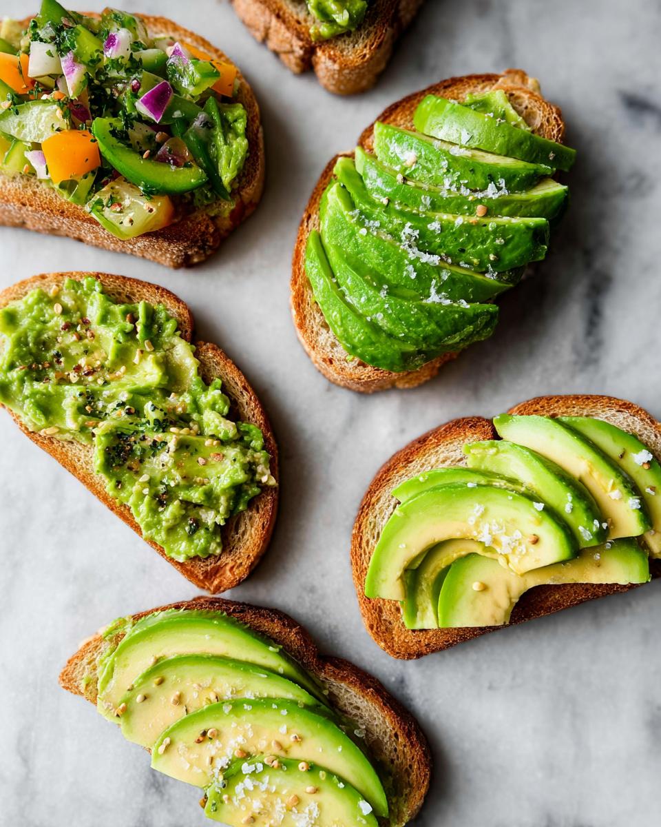 A variety of avocado toast options, including sliced avocado and mashed avocado with toppings.