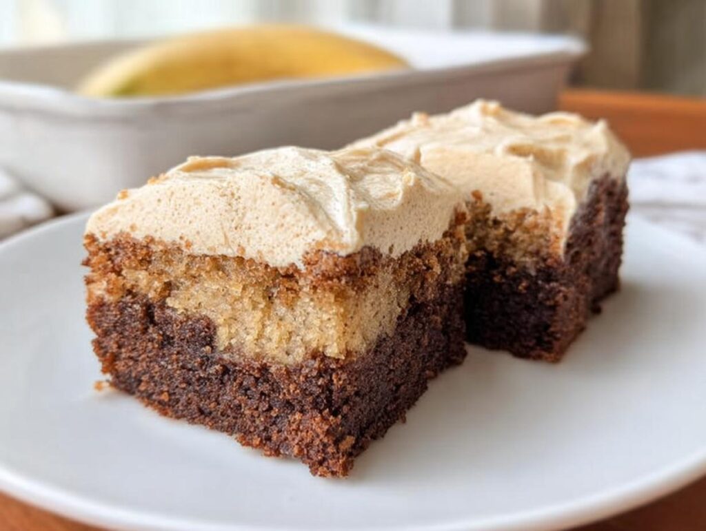 Two slices of Banana Bread Brownies Made Easy, layered with chocolate and banana bread, topped with creamy frosting.