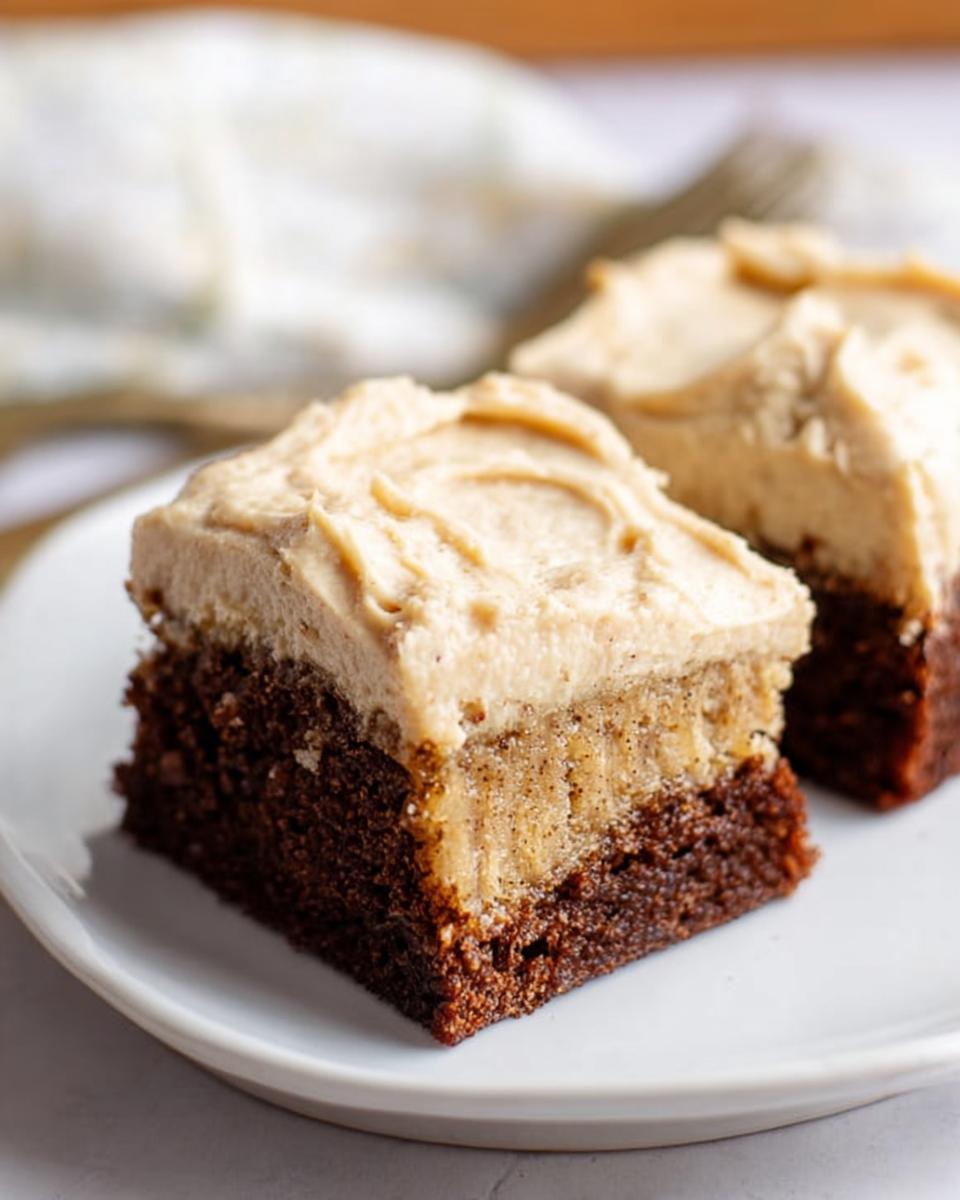 Two slices of Banana Bread Brownies Made Easy, featuring a rich chocolate base topped with banana bread layer and creamy frosting.