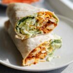 A delicious wrap filled with creamy spinach, eggs, shredded cheese, and lettuce.