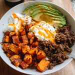 A delicious Ground Beef Hot Honey Bowl featuring seasoned ground beef, roasted sweet potatoes, creamy yogurt, and sliced avocado.